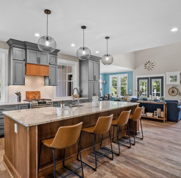 The interior design of a beautiful kitchen with a large island in a modern new England colonial home